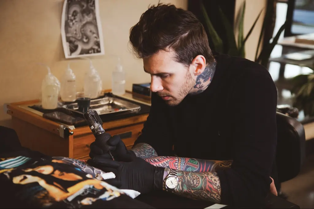 Tattoo artist working
